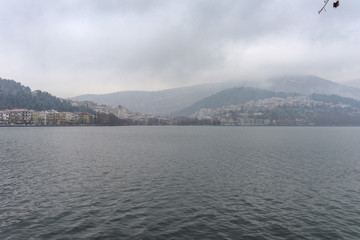 Foggy winter scenery at the lake of Kastoria Greece, during a he - 136320635