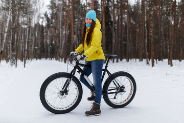 Photo of young girl in yellow jacket at winter cycling