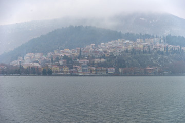 Foggy winter scenery at the lake of Kastoria Greece, during a he - 136320655