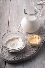 Dairy farm products on the white wooden table  vertical