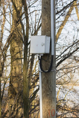 Plastic cabinet on a wooden pole.
