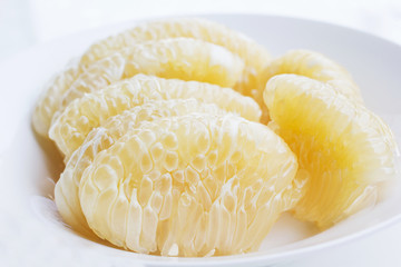 Fresh peeled pomelo fruit isolation on white