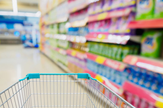 shopping cart with supermarket blur background