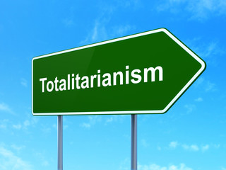 Politics concept: Totalitarianism on road sign background
