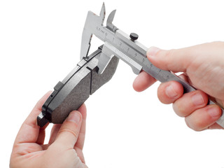 Brake pads with caliper on engineer hand.