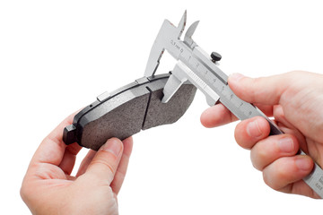 Brake pads with caliper on engineer hand.