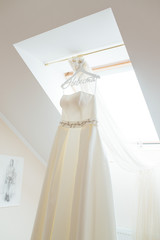 Wedding dress hanging in the middle of the room