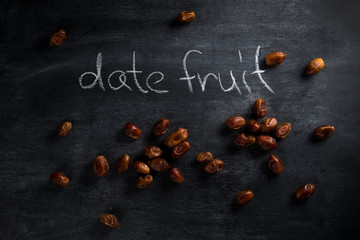 Date fruit over dark chalkboard background