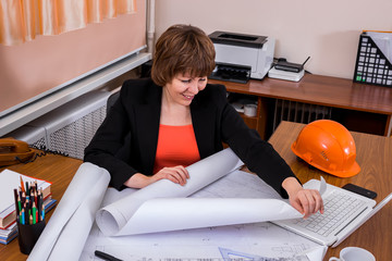 Architect woman working with  blueprints