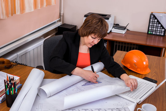 Architect woman working with  blueprints