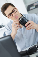 photographer soldering wireless flash trigger at his workplace