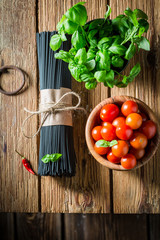 Fresh ingredients for spaghetti with tomatoes and basil