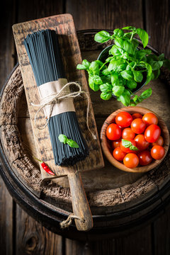 Homemade ingredients for black spaghetti with tomatoes