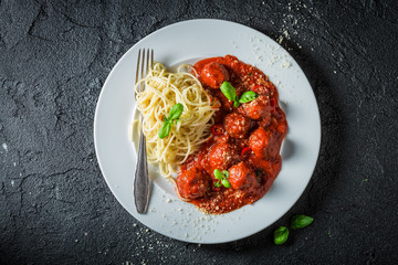 Fresh and tasty pasta bolognese with meatballs and parmesan