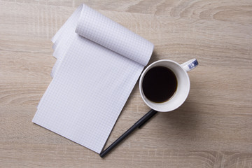 Notebook on the table.Coffee on the table. 