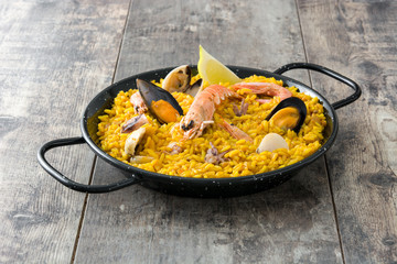 Traditional spanish seafood paella on wooden background
