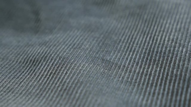 Indigo color velvet fabric tufted parallel cords close-up 4K 2160p 30fps UltraHD footage - Panning on dark blue twisted fibers of cotton corduroy 3840X2160 UHD video 