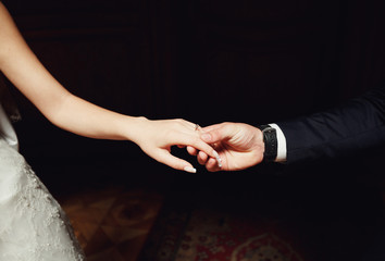 groom gently holding the bride's hand