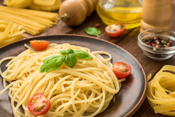 Tasty hot spaghetti with tomatoes and basil