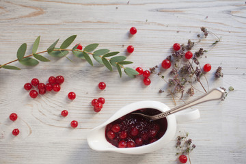 Serving table: sauce boat with berry jam.