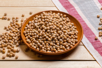 Soybeans over wooden table background