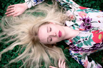 Naklejka premium happy young blondie european woman on the grass