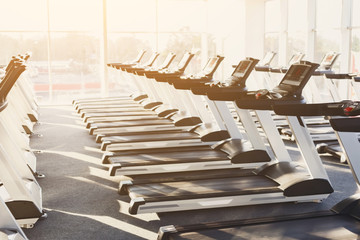 Modern gym interior with equipment, treadmills for fitness cardio training