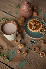 Serving table: cacao, cake with Walnuts and sugar-bowl.