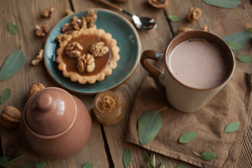 Serving table: cacao, cake with Walnuts and sugar-bowl.