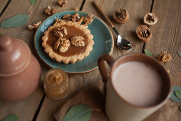 Serving table: cacao, cake with Walnuts and sugar-bowl.