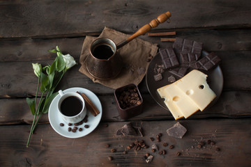 Serving table for breakfast: coffee, cheese and chocolate.