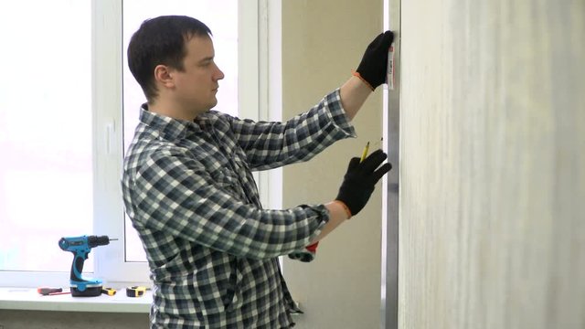adult builder with white prints and ruler