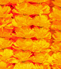 Naklejka na ściany i meble Orange artificial flowers arranged in rows background/texture