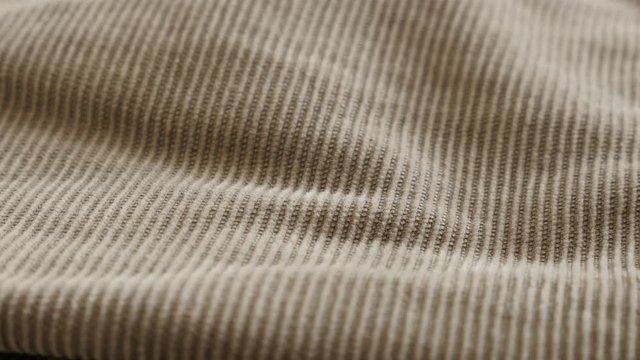 Cotton corduroy twisted fibers 4K 2160p 30fps UltraHD tilting footage - Brown velvet fabric tufted parallel cords shallow DOF close-up slow tilt 3840X2160 UHD video 