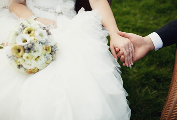 Beautiful romantic newlyweds holding hands