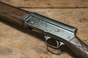 hunting rifle on rustic wooden background