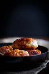 fried pork chops in a frying pan