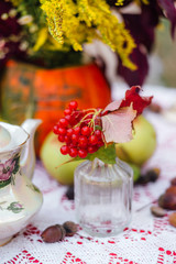 Decorated autumn wedding. Rustic. Wedding decor, wildflowers, bouquet, table setting, candles, pumpkin, books