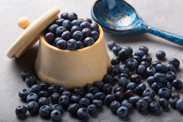 garden blueberries in a wooden pot and vintage wooden spoon