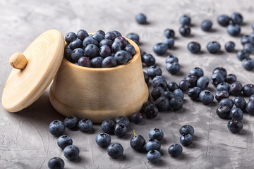 garden blueberries in a wooden pot and vintage wooden spoon