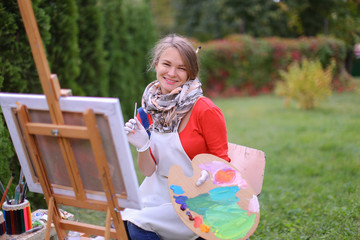 Women beautiful painter posing and smiling, laughing into camera