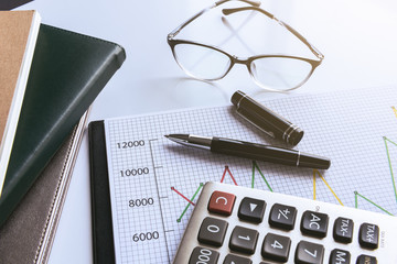 Eyeglasses and pen on financial document with data