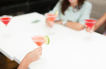 women drink cocktails at the restaurant celebrating