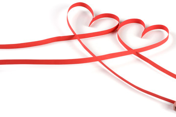 Two hearts made of red paper ribbon isolated on white background