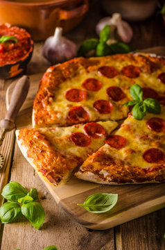 Homemade cheese pizza with salami