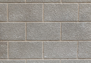 wall of big grey cement bricks, horizontally, with flat seams