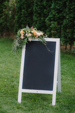Chulk board, which stands on the grass with wedding inscription