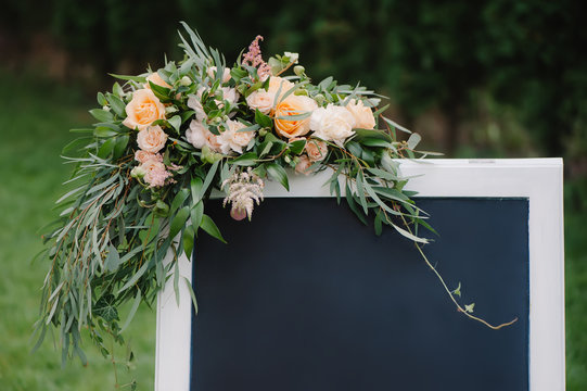 Chulk board, which stands on the grass with wedding inscription