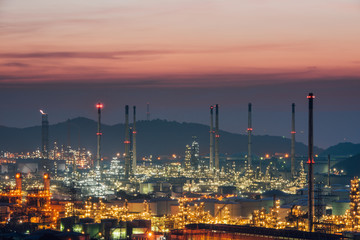 Obraz na płótnie Canvas Aerial view oil refinery night with mountain background during twilight,Industrial zone,Energy power station.