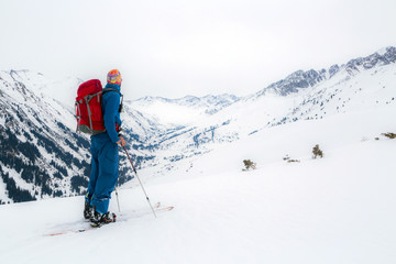 Fototapeta na wymiar Man standing at top of ridge. Ski touring in mountains. Adventure winter extreme sport. kyrgyzstan. Tian-Shan